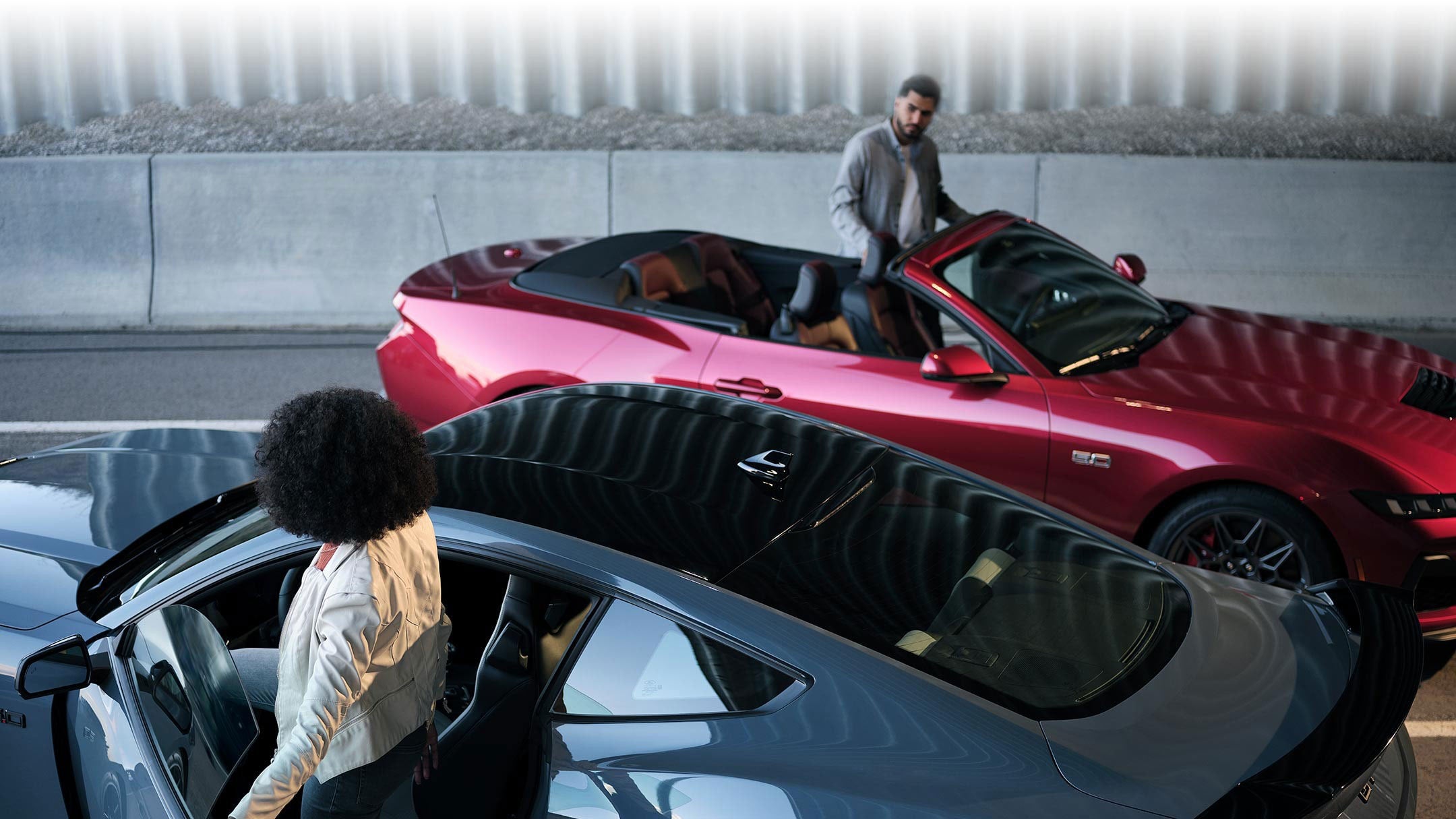 Two people exiting their parked 2024 Ford Mustang® coupe and convertible | Bergstrom Ford of Oshkosh in Oshkosh WI