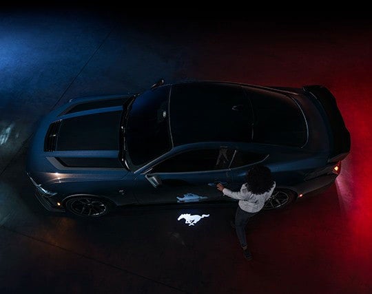 2024 Ford Mustang® Dark Horse™ model with a driver approaching the vehicle | Bergstrom Ford of Oshkosh in Oshkosh WI